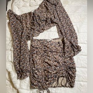 Floral ruffle skirt set with drawstrings and slits.